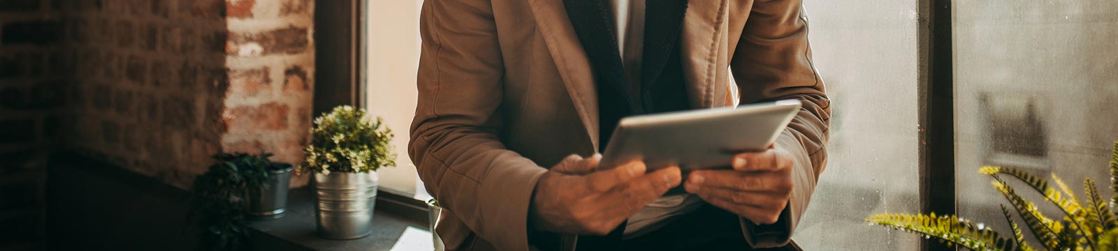 Business man holding a tablet.