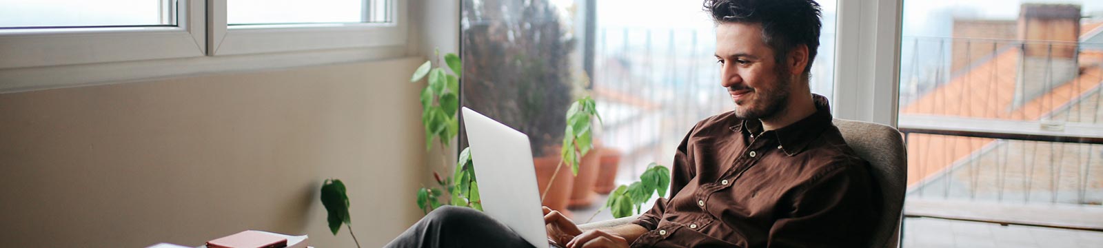 Man using laptop in home office.